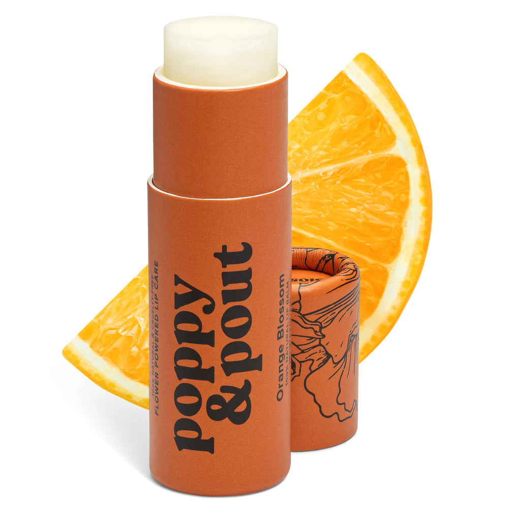 Poppy & Pout Orange Bloom Jumbo Lip Balm tube in hand with eco packaging and hydration.