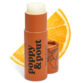 Poppy & Pout Orange Bloom Jumbo Lip Balm tube in hand with eco packaging and hydration.