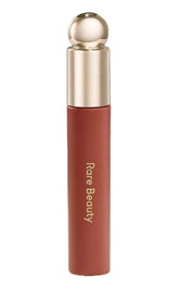 Rare Beauty Soft Pinch Lip Oil Stain Honesty on lips, nude brown tint with gloss-like sheen.