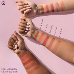 Close-up of Rare Beauty Stay Vulnerable lip balm in nearly mauve providing soft shine and cushion.