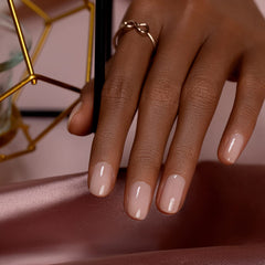 Swatch shows neutral apricot nude shade with fine holographic shimmer.