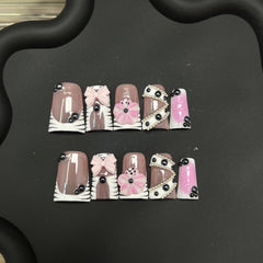 RIICFDD nails show black rhinestones and a 3D bow for glamorous events