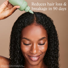 Rizos Curls applying serum to the scalp for targeted nourishment.