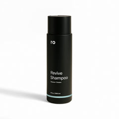 Ro Men's Revive Shampoo bottle pouring for a refreshing cleanse and fuller-looking hair.