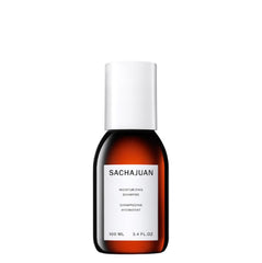 SACHAJUAN Moisturizing Shampoo bottle pouring for hydrating and frizz control.