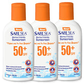 SAFE SEA jellyfish sting-blocking sunscreen bottle on sandy beach, SPF 50+ protection for sun and sea