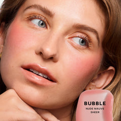 Saie Glossybounce swatch shows sheer, lip-enhancing color with glassy shine.