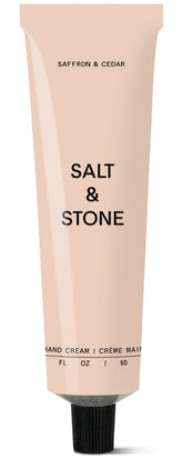 Salt and Stone hand cream bottle with saffron and cedar scent for daily hydration.