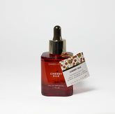 Sand + Fog Cherry Silk bottle showcases premium parfum oil for long-lasting fragrance