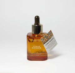 Sand + Fog Citrus Blossom amber glass packaging protects the oil and elevates vanity appeal.