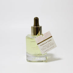 Close-up of Sand + Fog Vanilla Cake Parfum Oil dropper for targeted application.