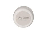 Skincando Eye Balm jar highlighting dark circles and brightened under-eye area.