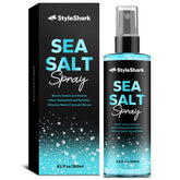 StyleShark Sea Salt Spray bottle on desk adds beachy texture and volume.
