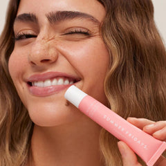 Summer Fridays Pink Sugar lip balm being applied on lips for hydration.