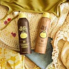 Sun Bum sunscreen spray mist on skin demonstrates easy, even application outdoors.