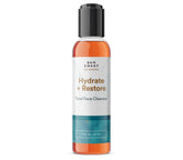 Sun Coast Sciences Hydrate + Restore cleanser bottle with creamy lather for daily cleansing.