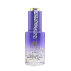 TATCHA Gold Camellia Beauty Oil bottle close-up with 23k gold flakes for radiant glow.