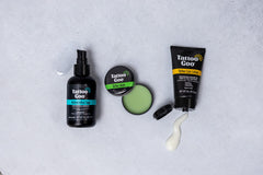 Tattoo Goo healing balm tube during application with olive oil-rich moisture
