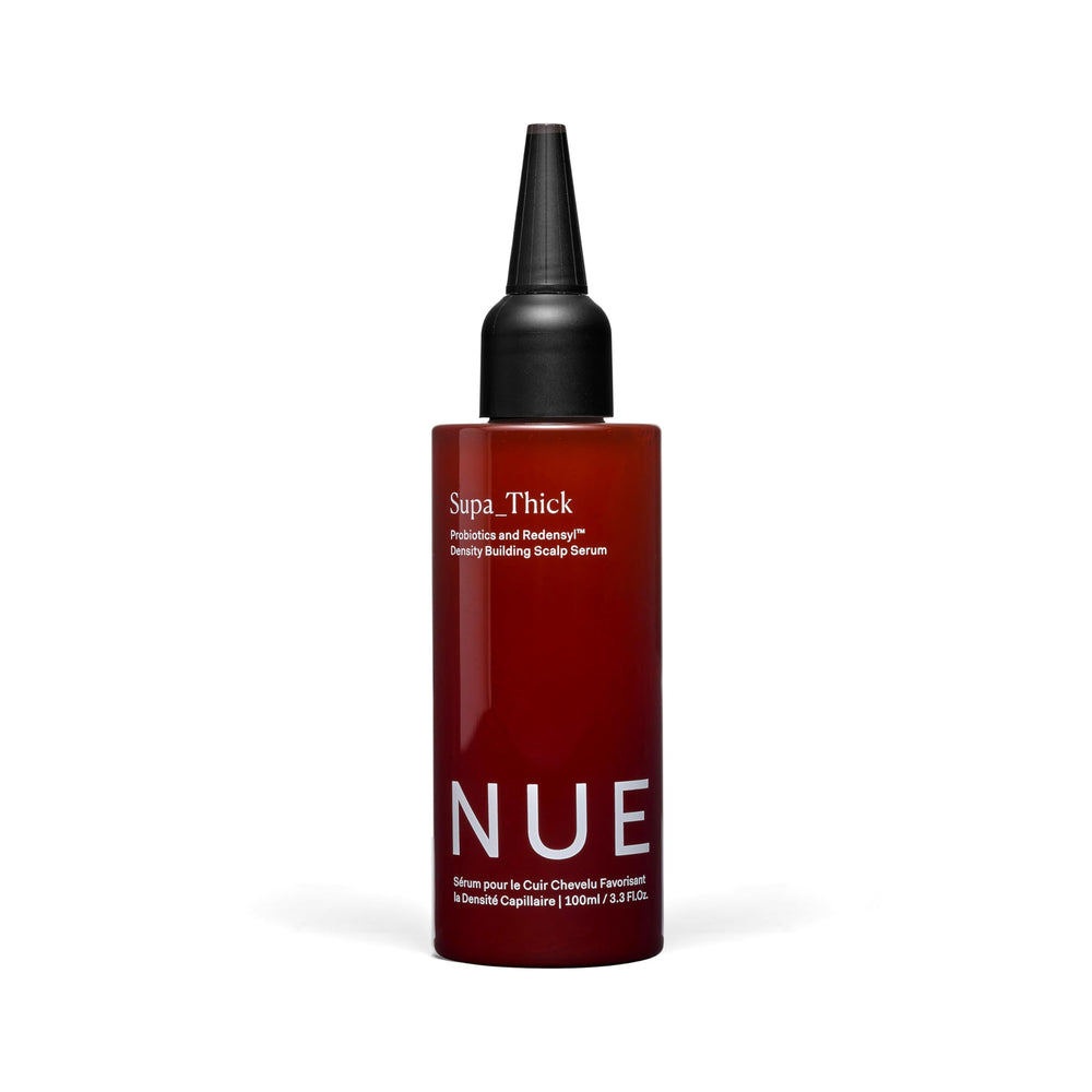 The Nue Co Supa Thick Hair Serum bottle close-up for easy daily use.