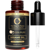 The Organic Forest sesame oil bottle, cold-pressed purity for skin care.