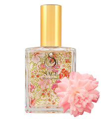 The Sage Lifestyle Rose Quartz spray bottle, a portable luxury fragrance for on-the-go wear.