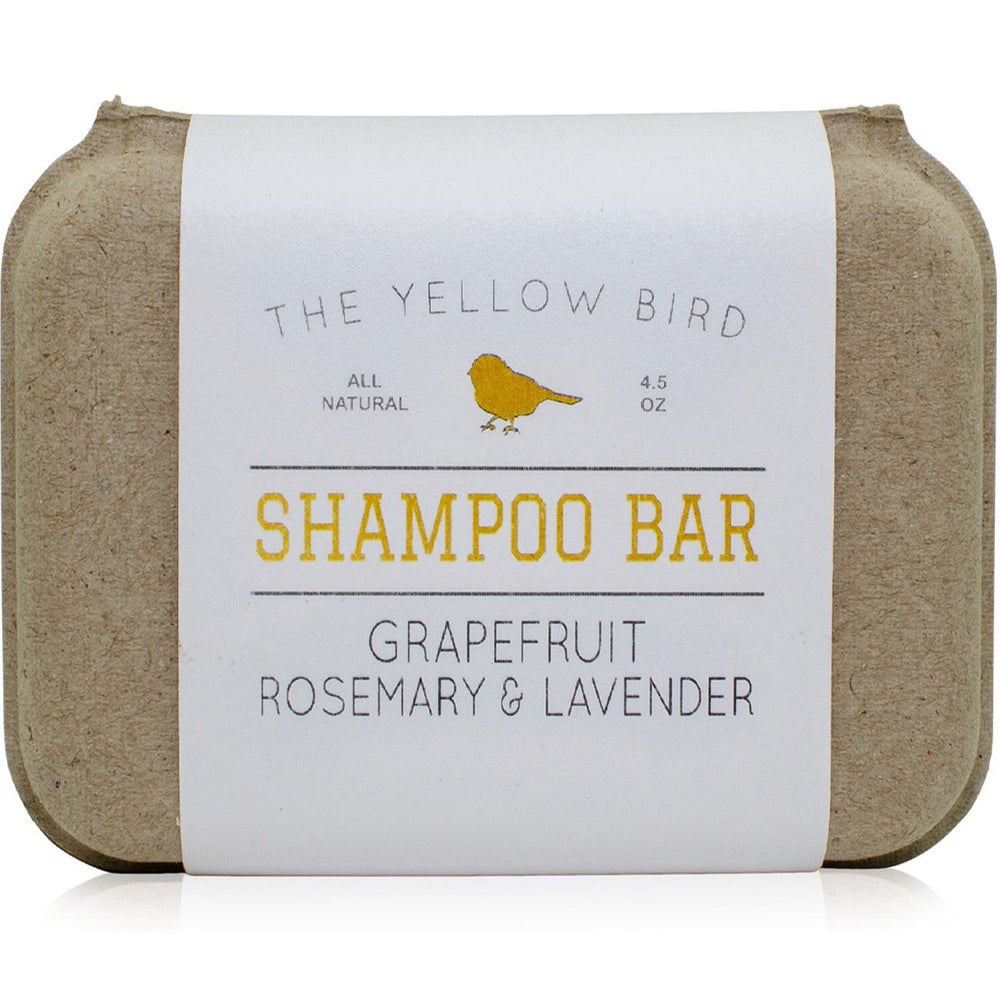 The Yellow Bird solid bar shampoo close-up showing grapefruit-rosemary-lavender aroma for gentle cleansing.