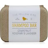 The Yellow Bird solid bar shampoo close-up showing grapefruit-rosemary-lavender aroma for gentle cleansing.