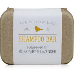 The Yellow Bird solid bar shampoo close-up showing grapefruit-rosemary-lavender aroma for gentle cleansing.