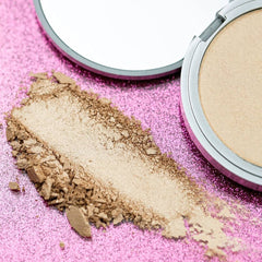 theBalm Mary-Lou Manizer swatch shows champagne shimmer on skin