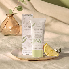 Thymes hand cream fragrance swirls highlighting eucalyptus and lemon notes for a spa-like aroma.