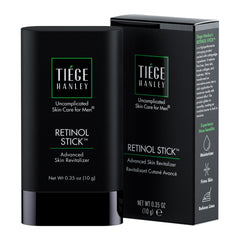 Tiege Hanley Retinol Stick on forehead for smoother texture and hydration.