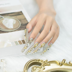 Applying Tmani nails with glue for quick, secure wear at home.