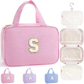 TOPEAST hanging toiletry bag in pink with initial S keeps cosmetics organized on the go.