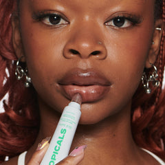 Topicals Slick Salve Mint Glossy Lip Balm on lips delivering moisture and shine