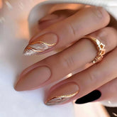 Tyuimhx almond press nails with brown marble and gold line, ideal for chic party looks.