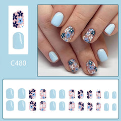 Tyuimhx glossy blue floral press-on nails demonstrating a polished, salon-like finish.