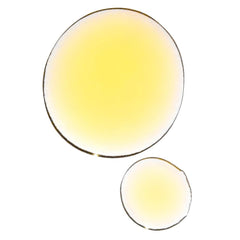 UMA Organic Ultimate Brightening Face Oil in hand ready for fast absorption and glow.