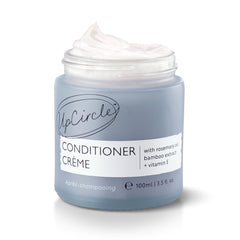 UPCIRCLE conditioner creme bottle highlights rosemary oil for gentle frizz control.