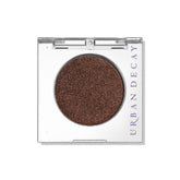 Urban Decay 24/7 Ember swatch shows deep copper pigment for bold lids.