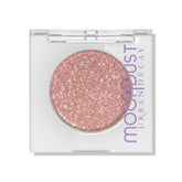 URBAN DECAY Moondust Crushin' Hard peach-pink swatch with silver pearls for everyday glow.