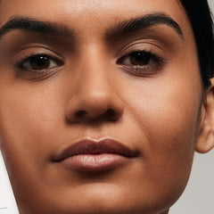 VASANTI Brighten Up New Skin Amplifying Moisturizer bottle close-up highlights aloe and vitamin C.