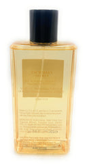 Victoria's Secret Bombshell Amalfi body mist bottle close-up showing notes of tangerine and blossom.