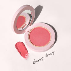 Wander Beauty Berry Busy being brushed onto cheek for natural flush.