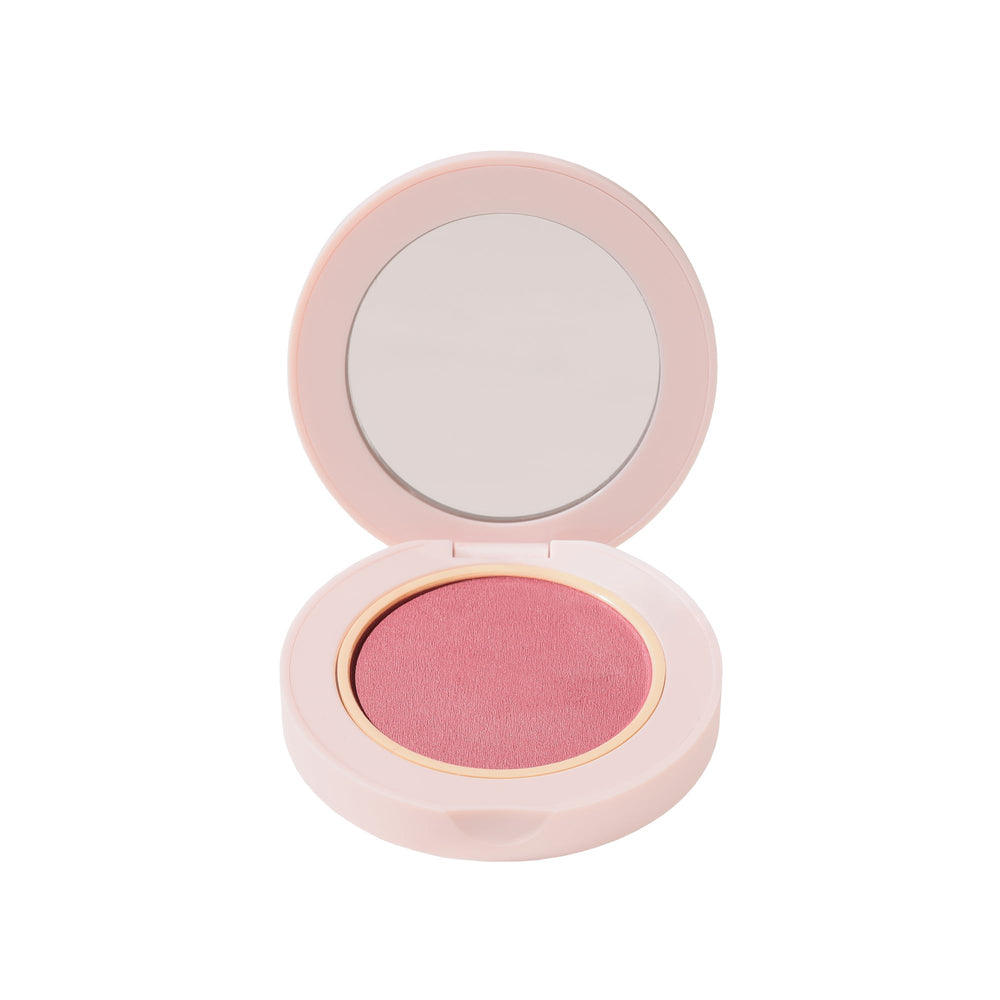 Wander Beauty hydrating powder blush Berry Busy swatch on skin for seamless blend.