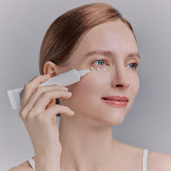 Whamisa Organic Flowers Eye Essence being gently applied around the eye for hydration