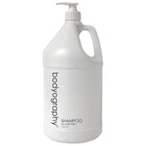 World Amenities Bodyography Blanc Shampoo bottle demonstrates luxurious self-care benefits for all hair types.
