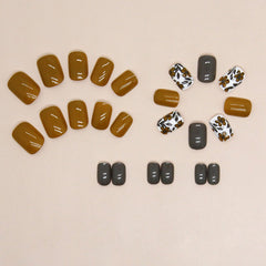 YOJIATOP floral design nails close up in yellow grey with glossy finish