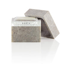 Zents Concreta balm in stone packaging enhances daily skincare ritual with earth fragrance.