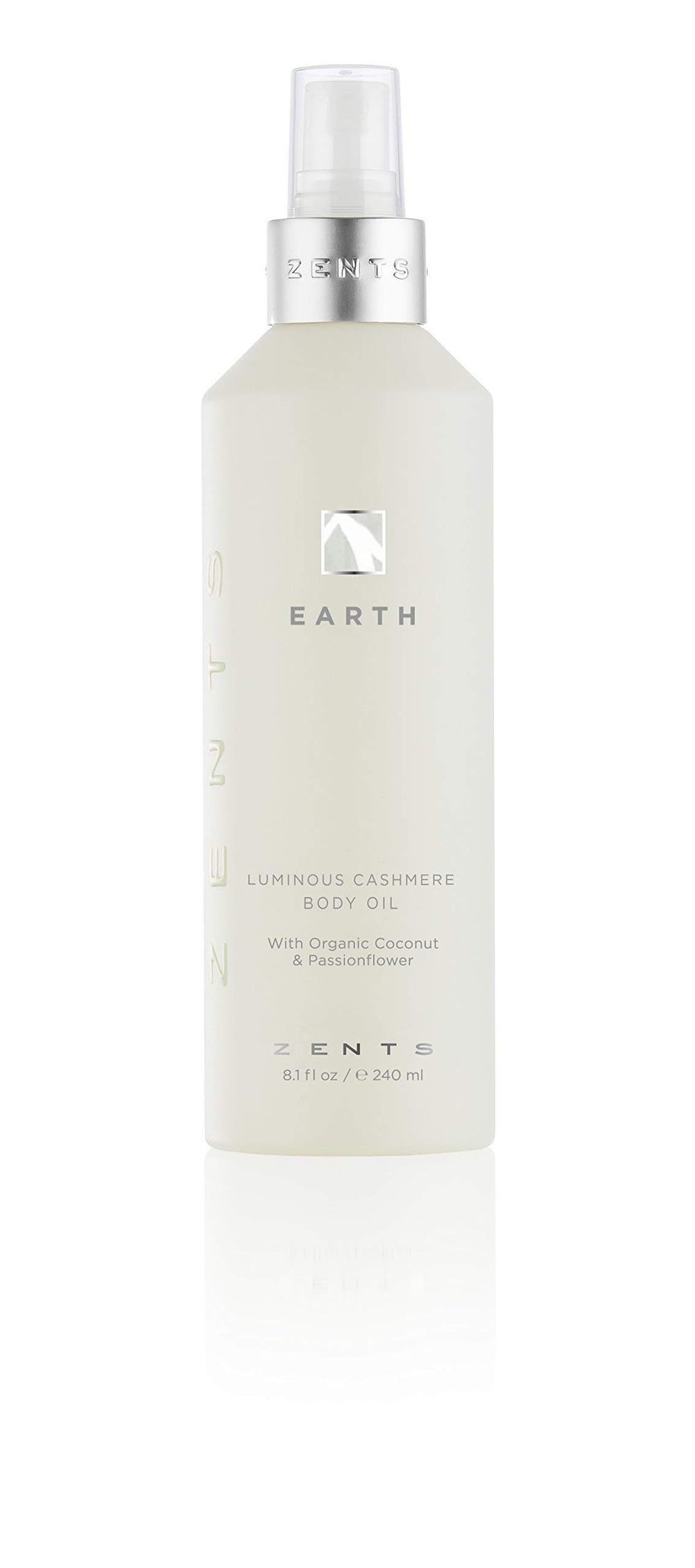 Zents Luminous Cashmere Body Oil Earth fragrance bottle pour for radiant hydration.