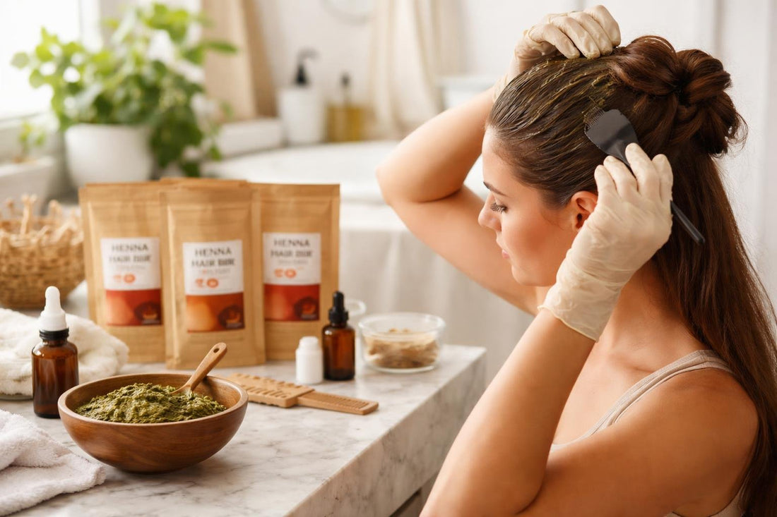 Beginner applying henna paste to sectioned hair
